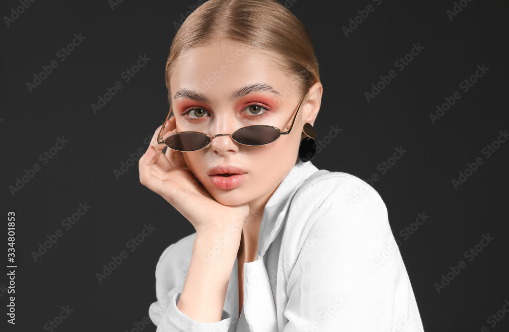 Beautiful fashionable woman on dark background