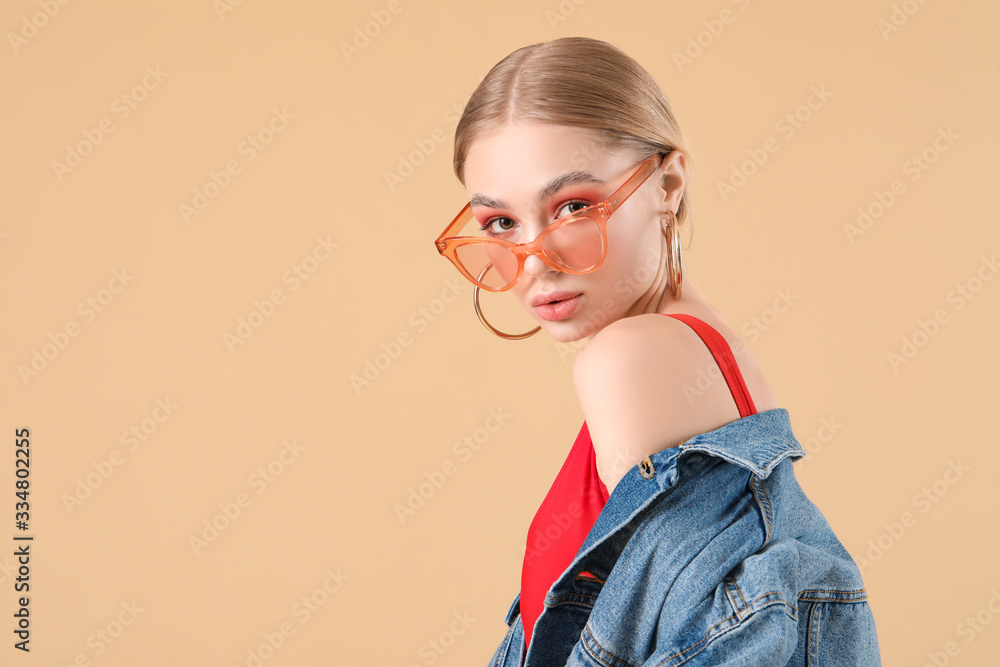 Beautiful fashionable woman on color background