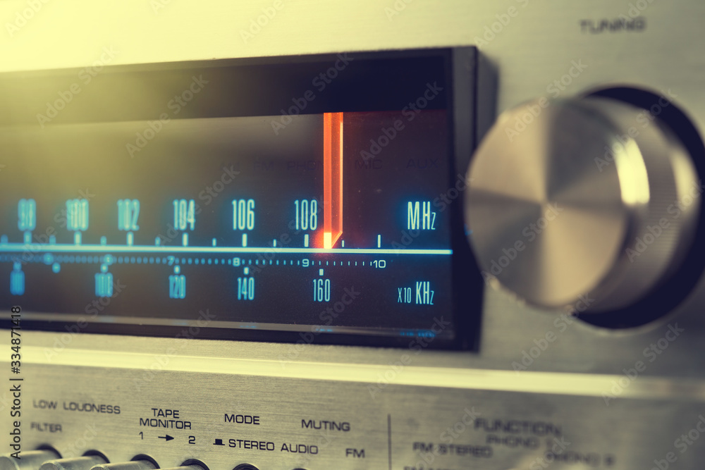 Classic radio tuner panel close-up. Black background