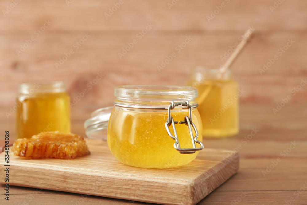 Jar of sweet honey on table