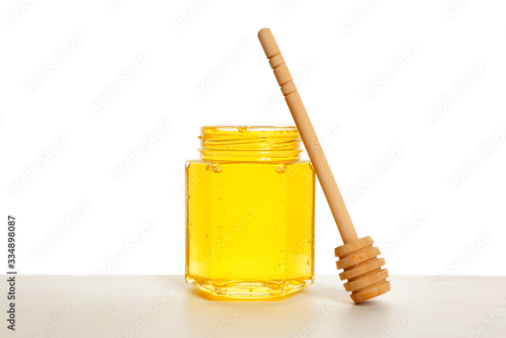 Jar of sweet honey on white background