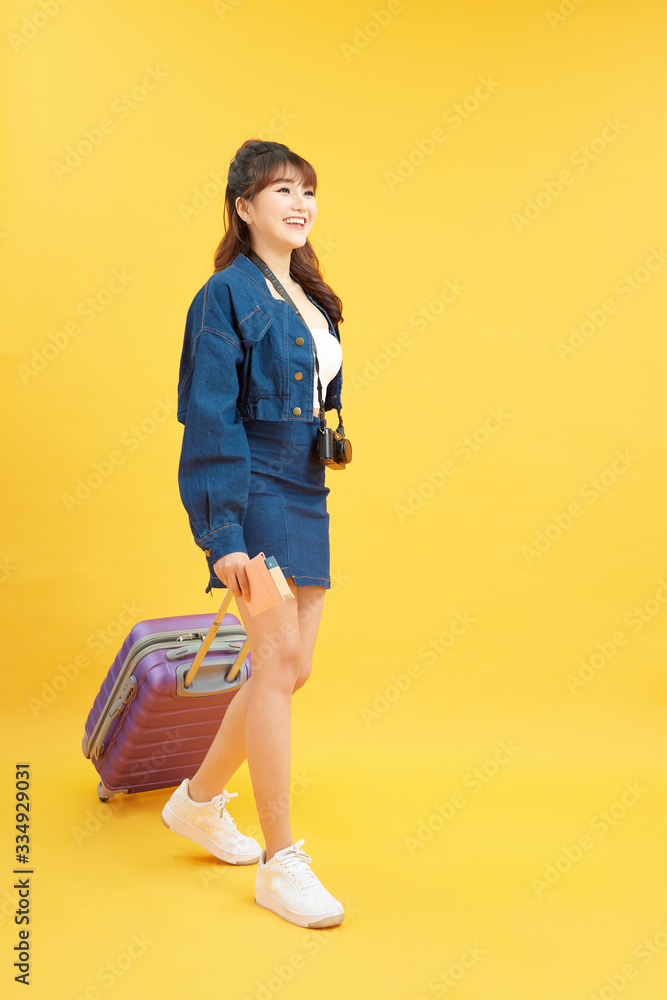 Traveler tourist woman in summer casual clothes with digital camera on neck isolated on yellow orang