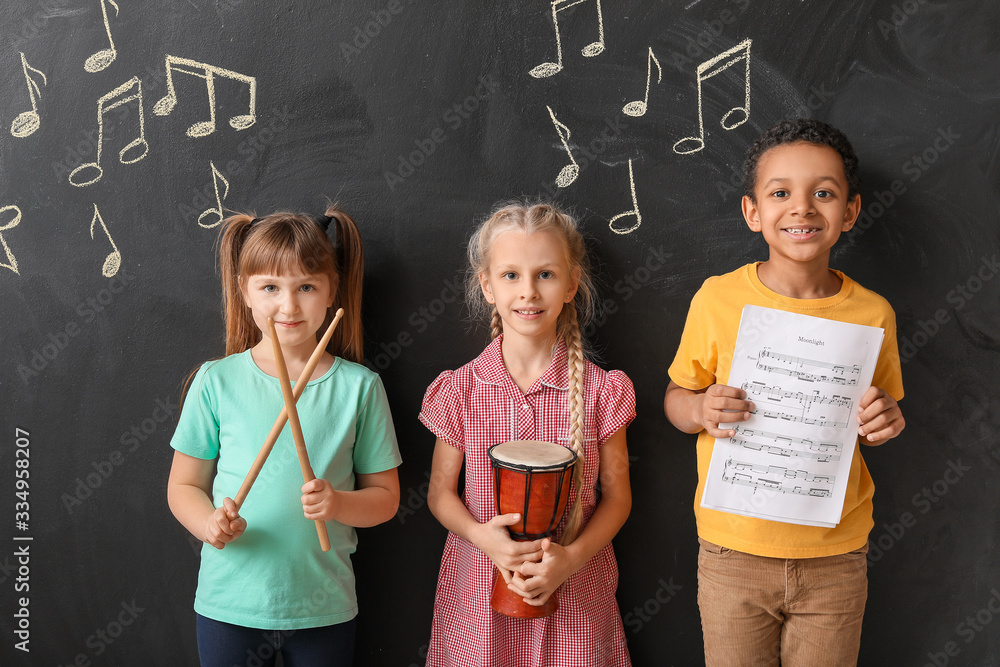 Little children near chalkboard at music school