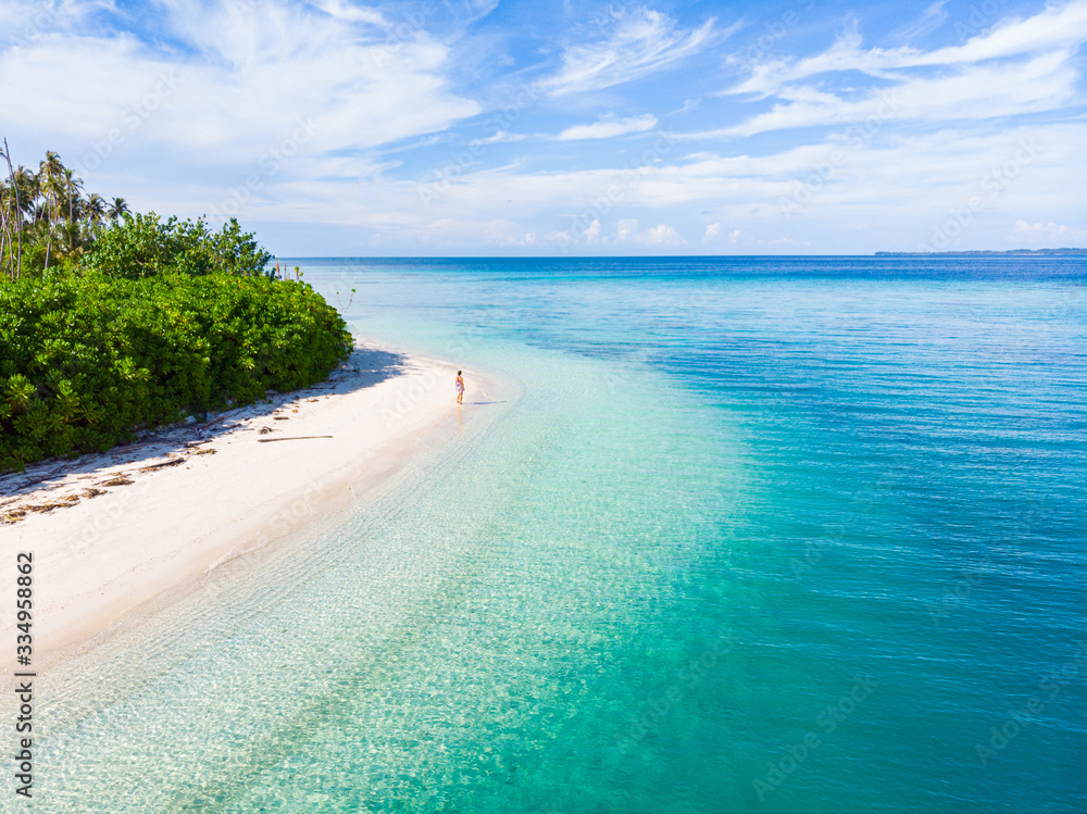 Couple on tropical beach at Tailana Banyak Islands Sumatra tropical archipelago Indonesia, Aceh, cor