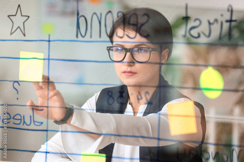 Young female designer planning her work in office