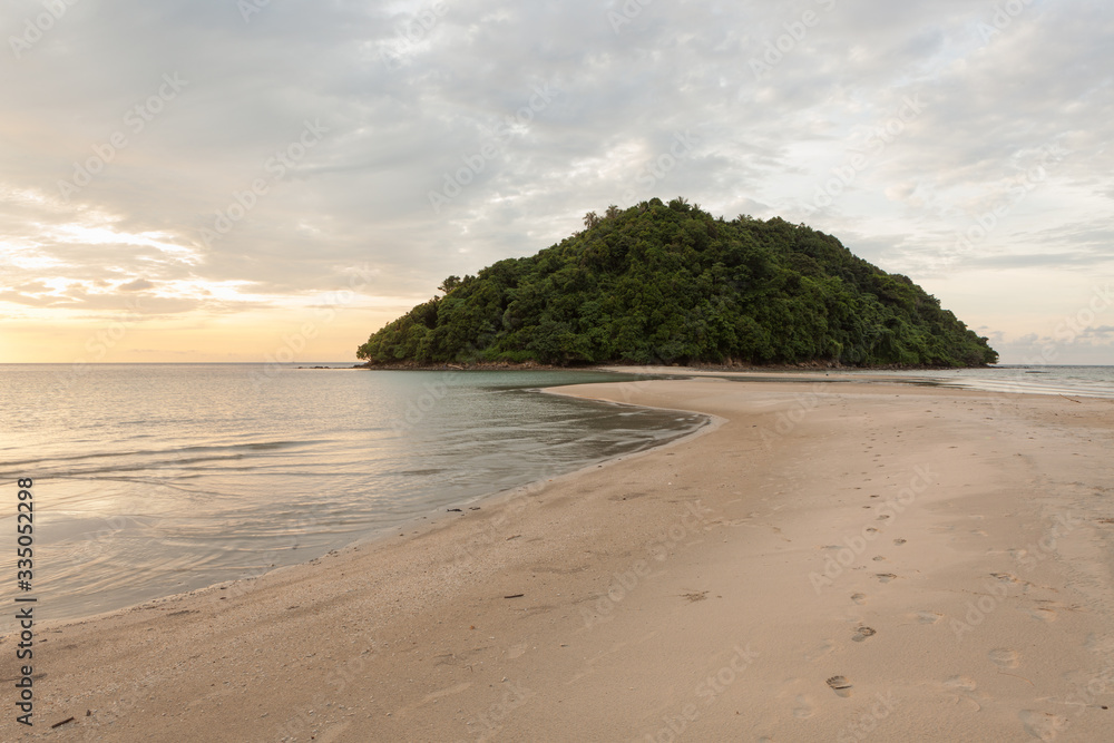 Tropical island and paradise beach at sunset