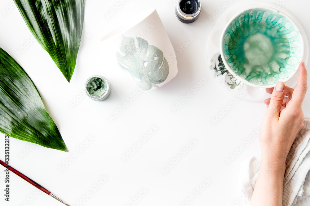 painted ceramic cup on white background top view