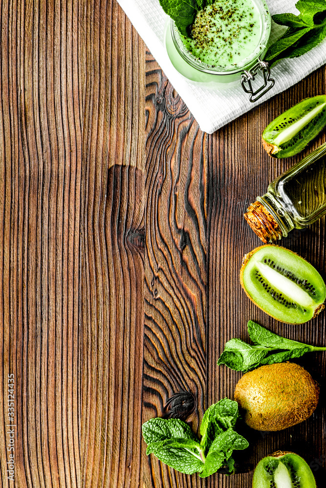 woman cosmetic set with kiwi scrub table background top view mock up