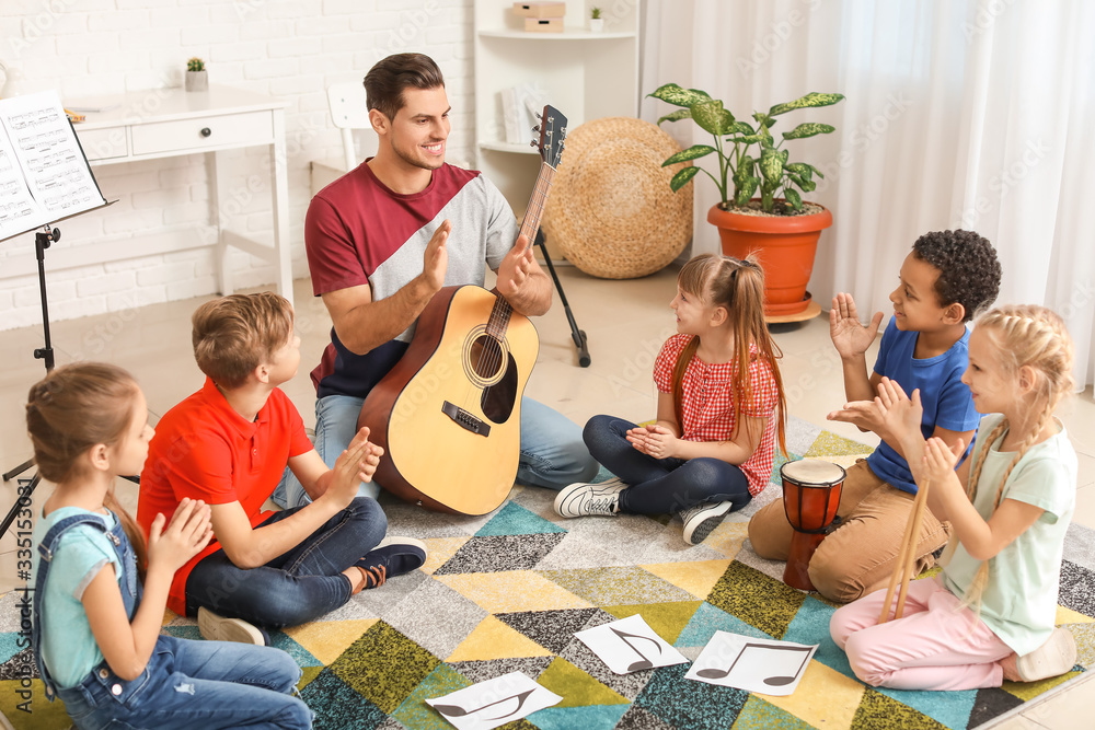 Teacher giving music lessons at school