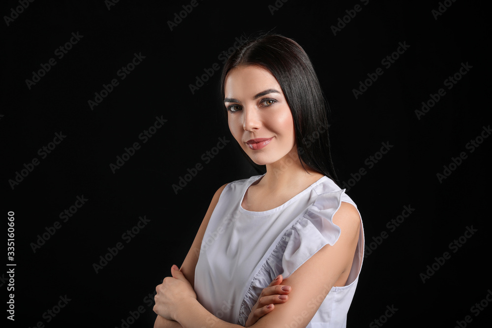 Young woman with beautiful healthy hair on dark background