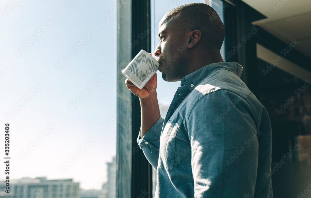 Businessman having coffee in modern office