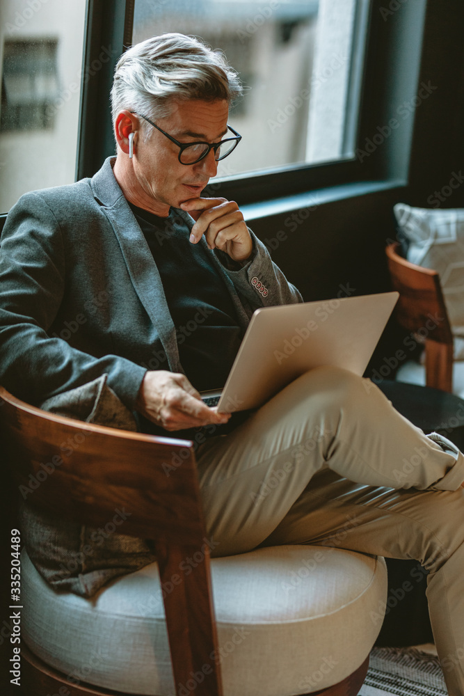 Businessman looking busy working on laptop