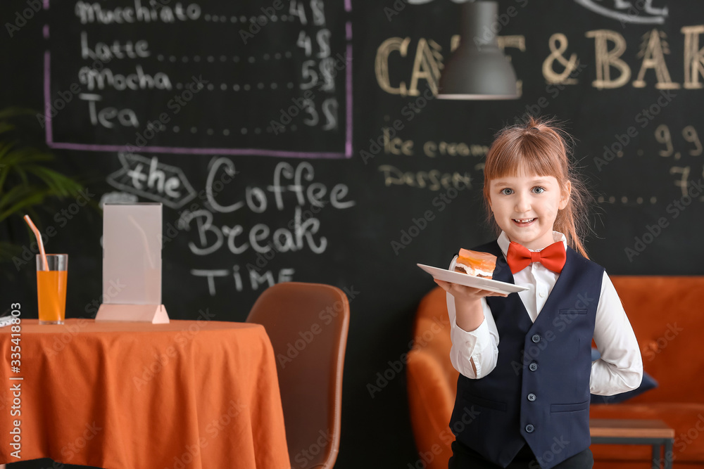 Cute little waiter in restaurant