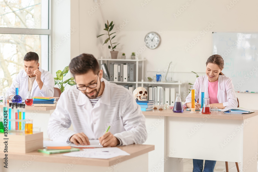 Young people at chemistry lesson in classroom