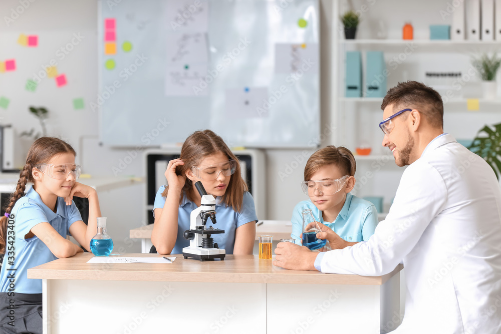 Teacher conducting chemistry lesson in classroom