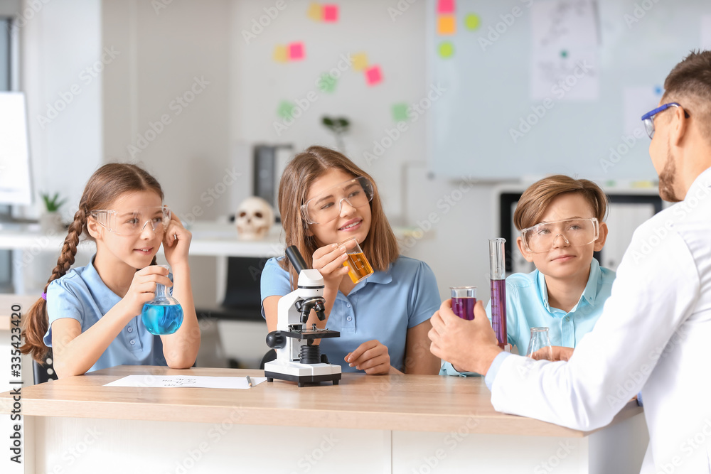 Teacher conducting chemistry lesson in classroom