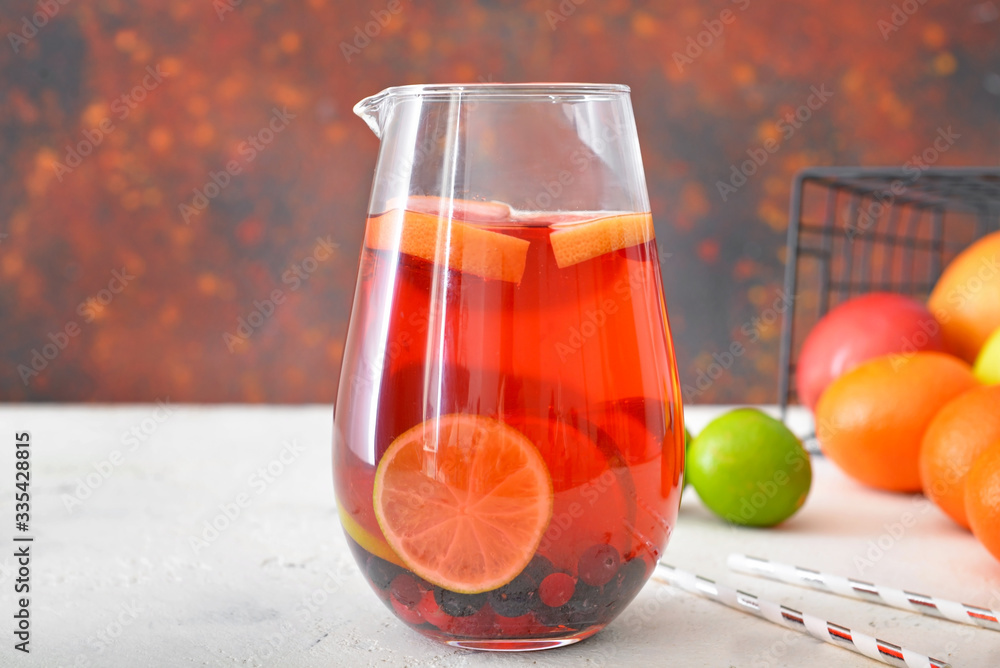 Jug of tasty cold tea on table