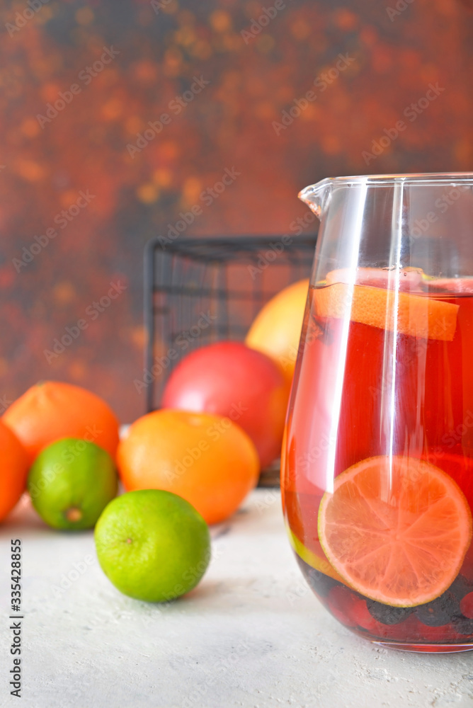 Jug of tasty cold tea on table