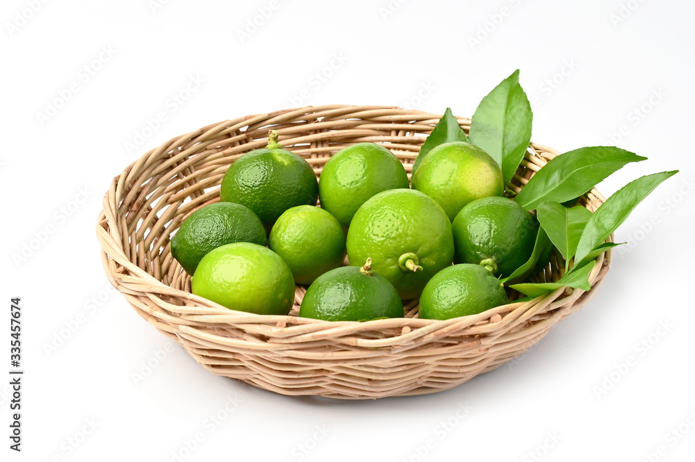 fresh lime in basket isolate on white background