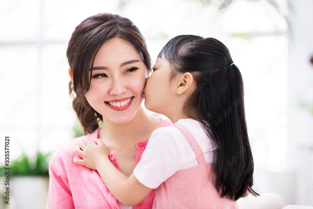 Daughter kiss mom tenderly