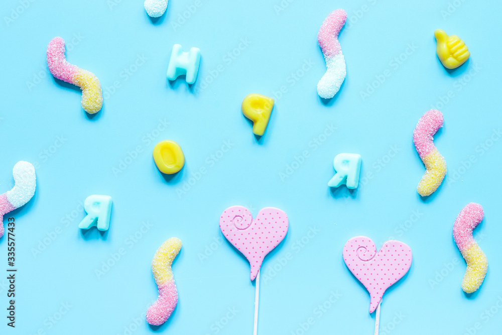 sweets and sugar candies on blue background top view pattern