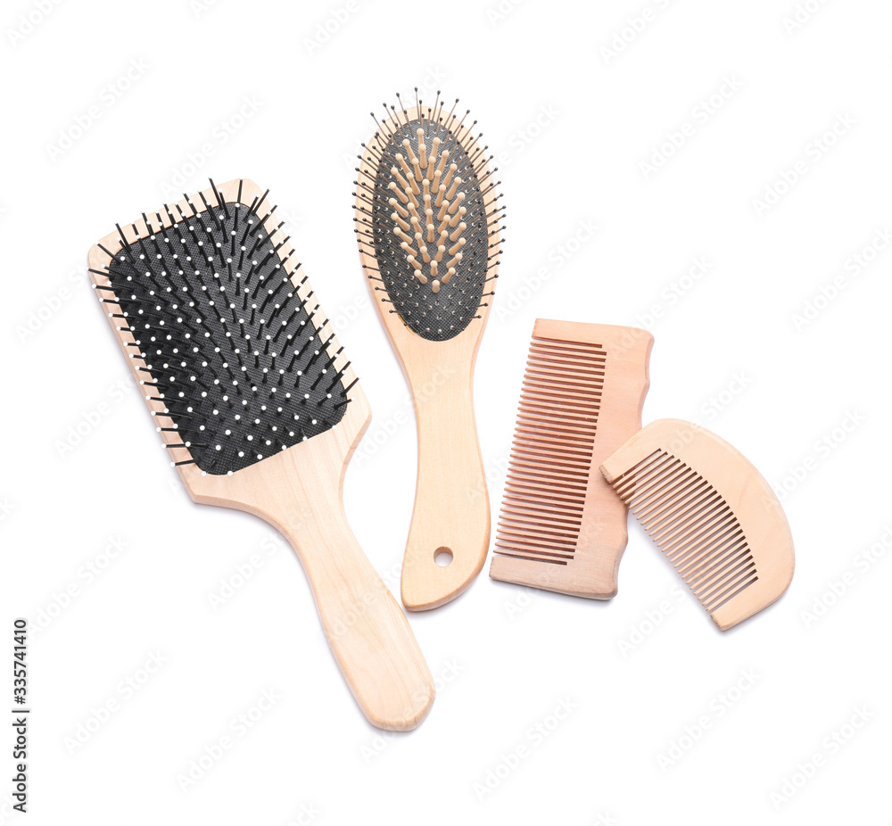 Hair brushes and combs on white background