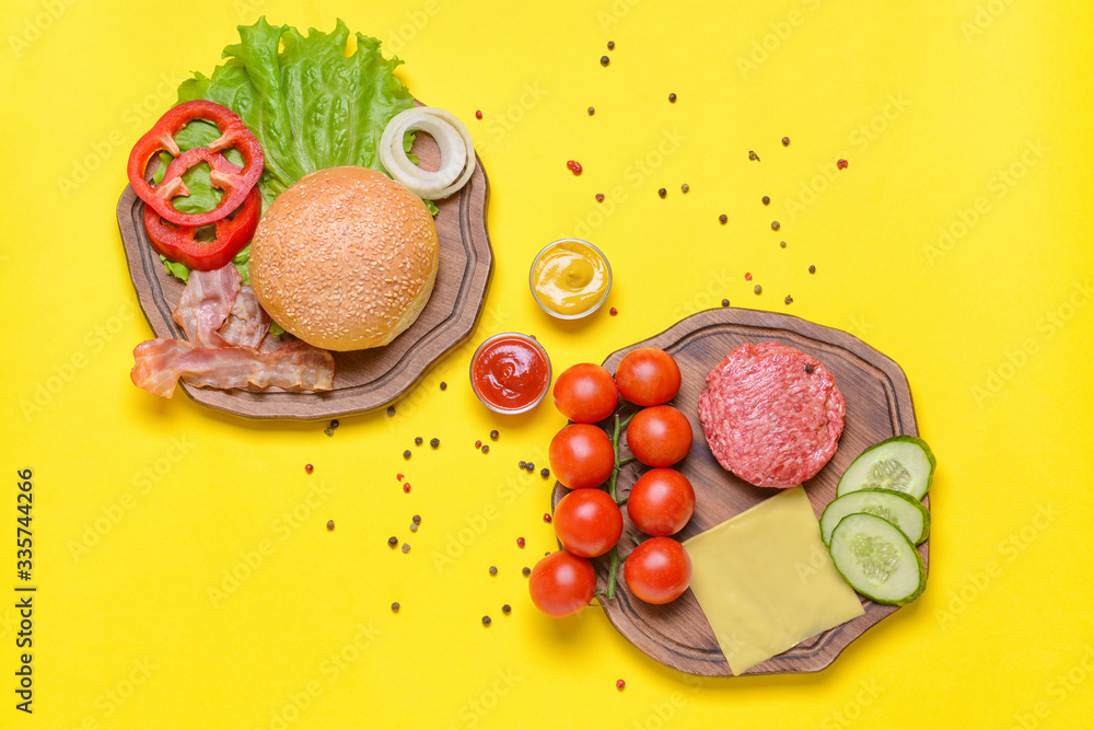 Ingredients for tasty burger on color background