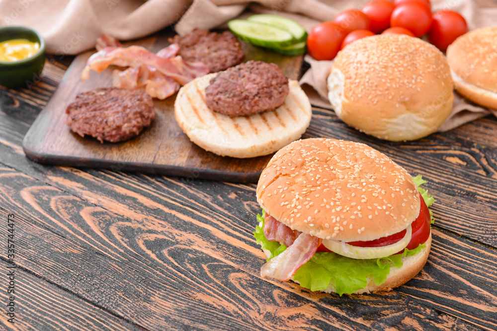 Ingredients for tasty burger on wooden table