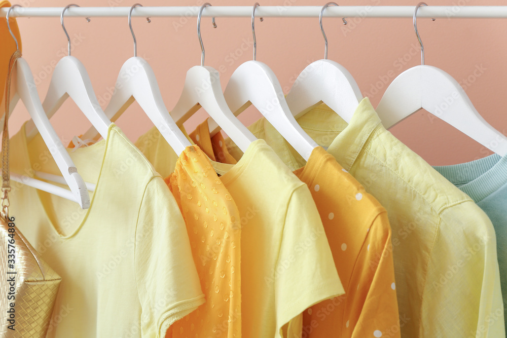 Modern clothes hanging on rack, closeup