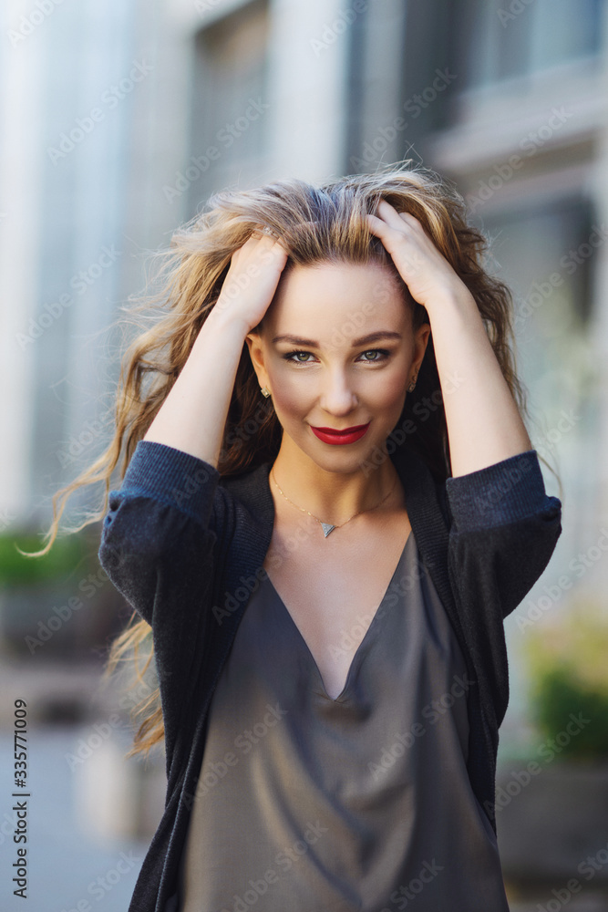 Portrait of a girl who pulls her hair in the street