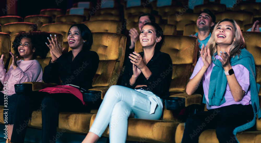 People audience watching movie in the movie theater cinema. Group recreation activity and entertainm