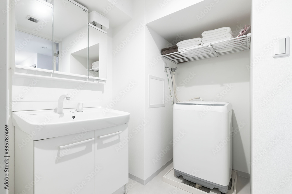 Washbasin and washing machine in the shower at a small apartment