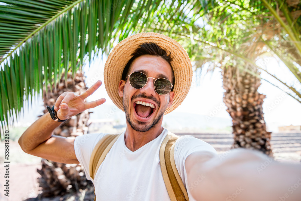 Handsome caucasian man taking a selfie portrait outdoor at vacation. 