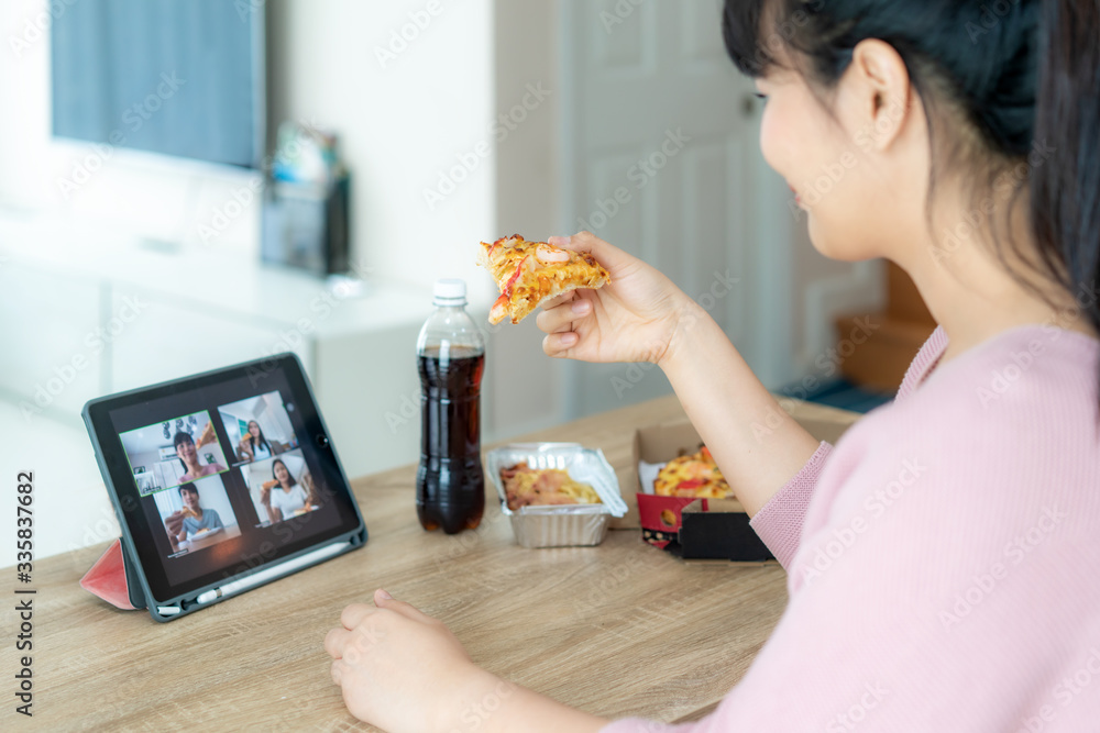 Asian woman virtual happy hour meeting party and eating food online together with her friend in vide