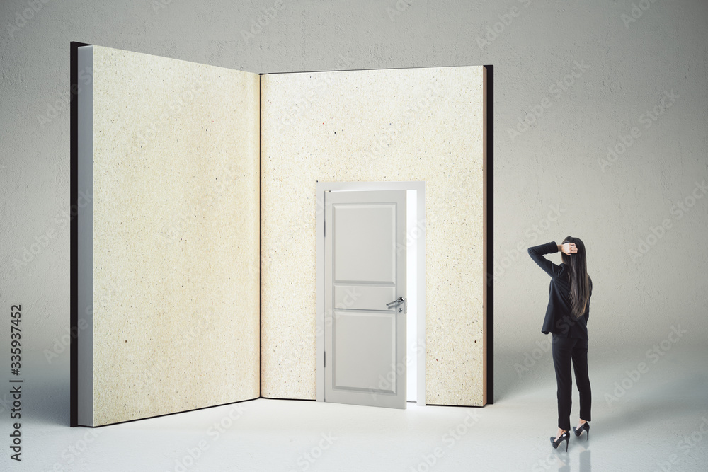 Pensive businesswoman looking at abstract open book with door.