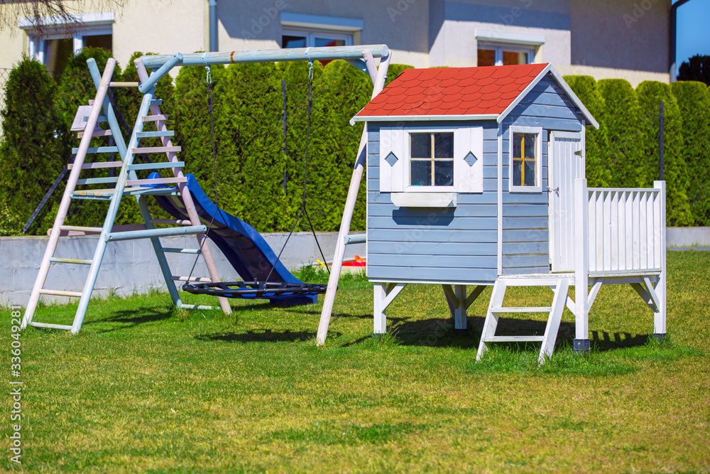 A beautiful wooden house for children and a garden playground