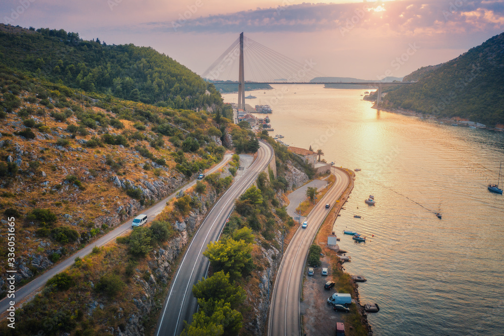 Aerial view of mountain roads  and beautiful bridge at sunset. Dubrovnik, Croatia. Top view of road,