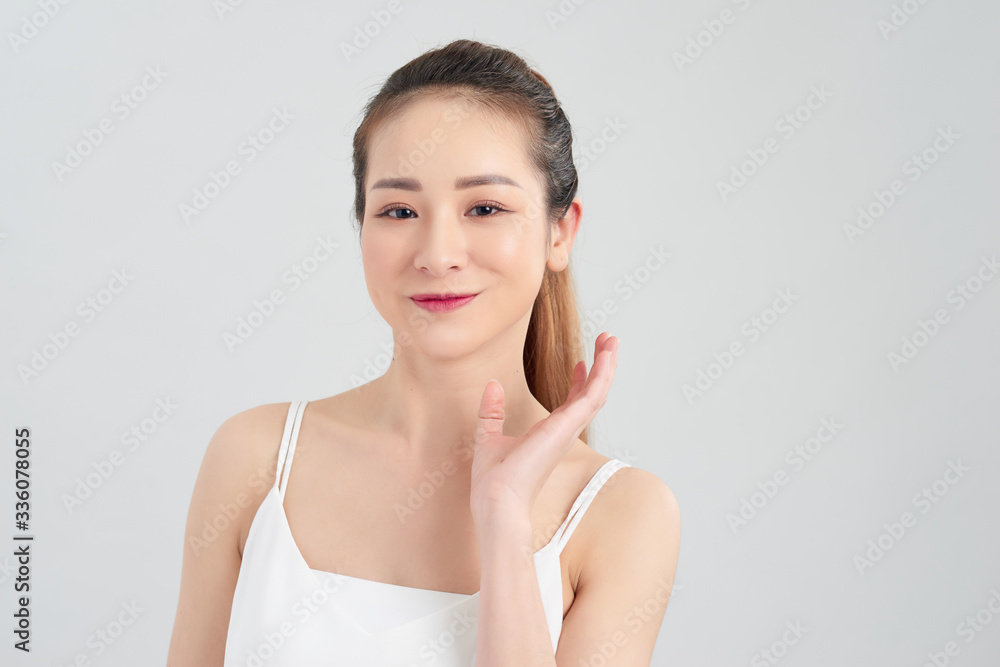 Portrait of beautiful young Asian woman over white background.