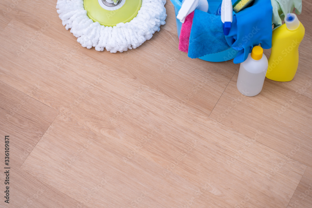 Mop floors. Young woman washing wooden ground floor at home with a mop, cleaning tool products, conc