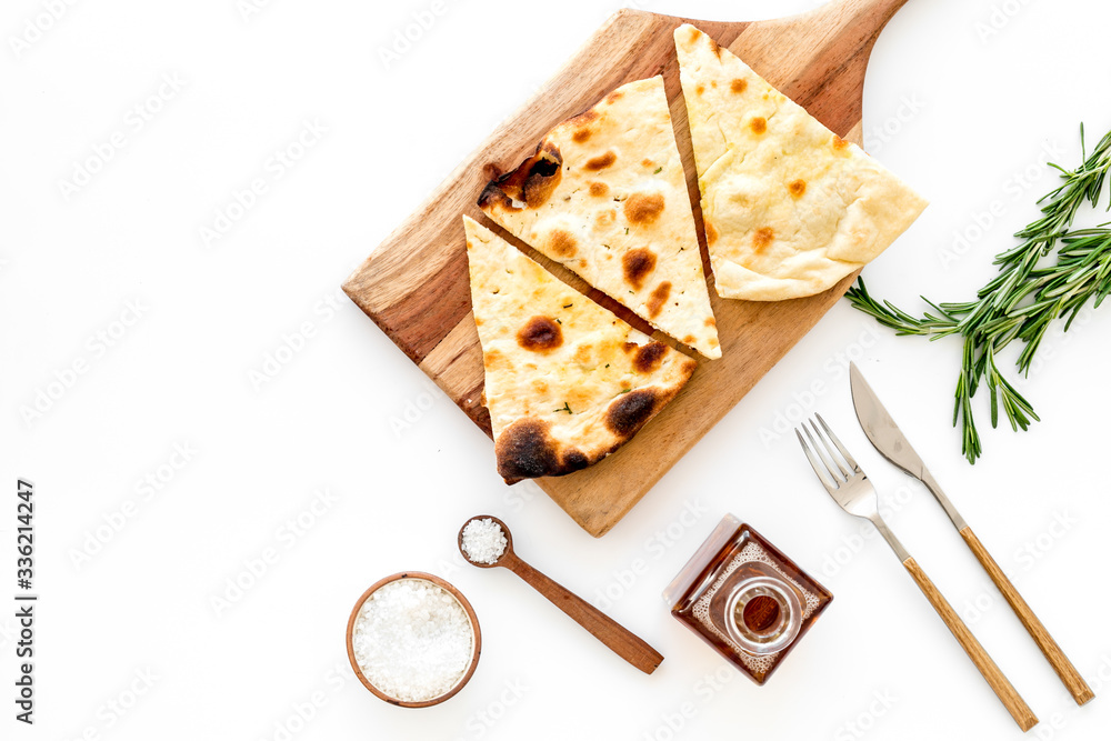 Italian focaccia with cheese and rosemary on white background top-down copy space