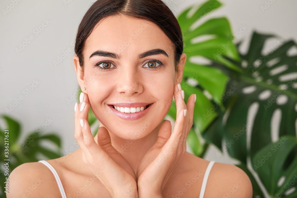 Beautiful young woman with healthy skin at home