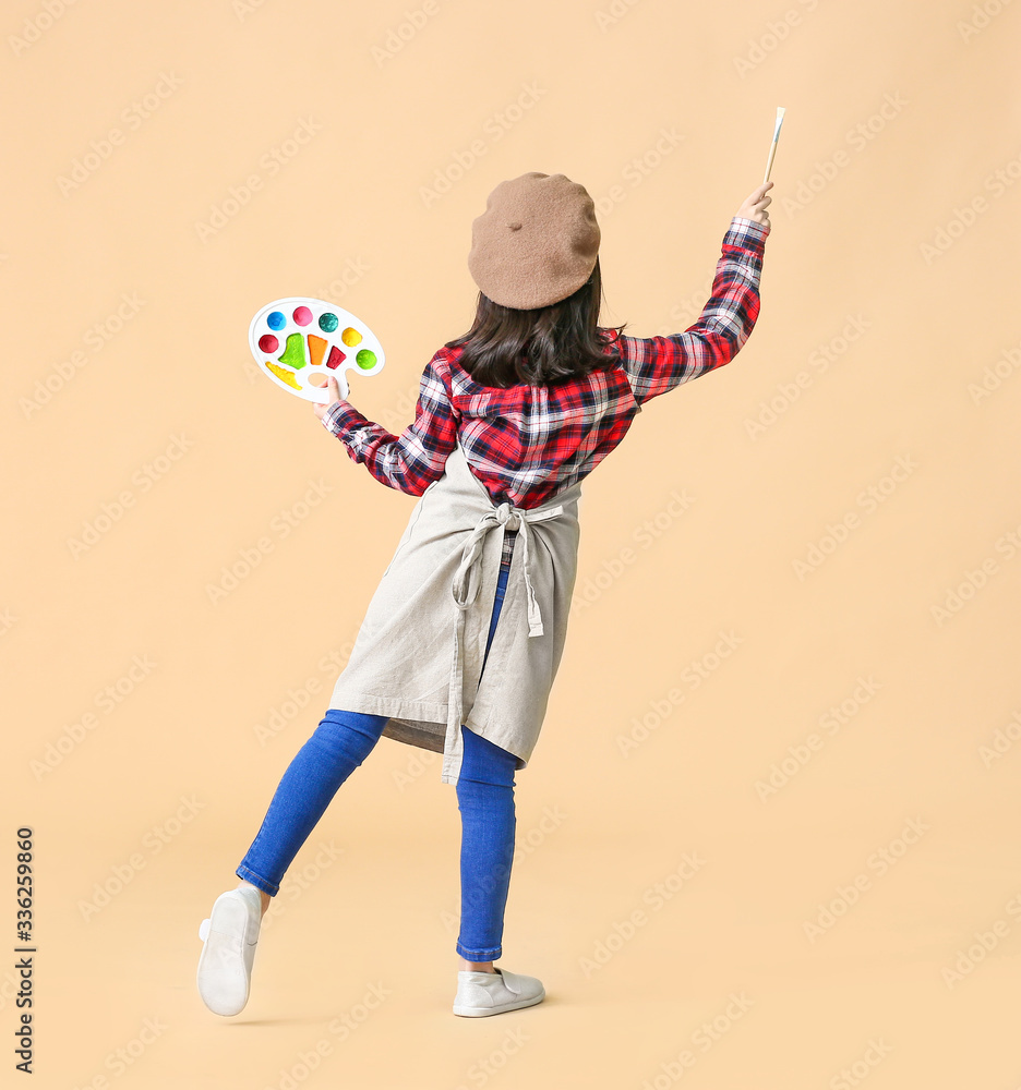 Cute little artist on color background