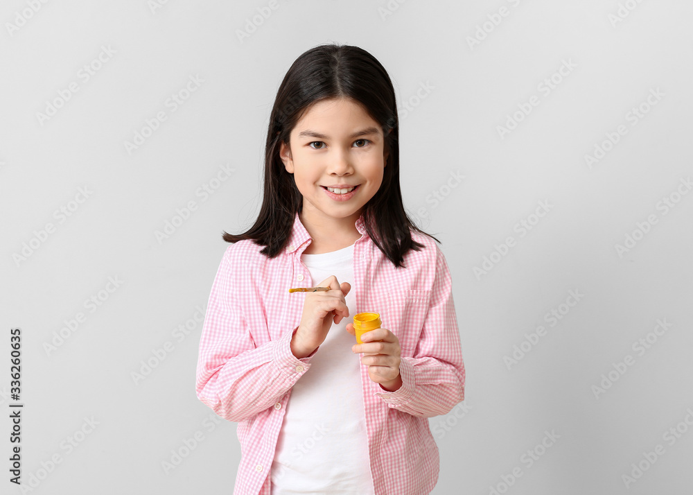 Cute little artist on light background