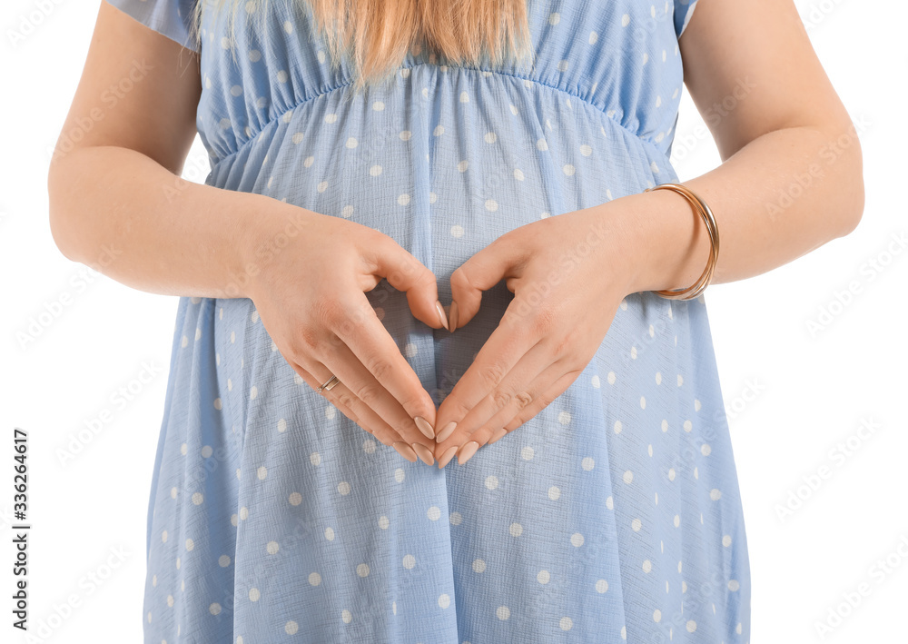 Beautiful pregnant woman making heart with her hands on white background, closeup