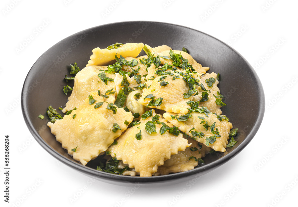 Plate with tasty ravioli on white background