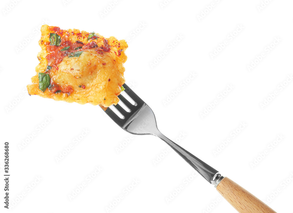 Fork with tasty ravioli on white background