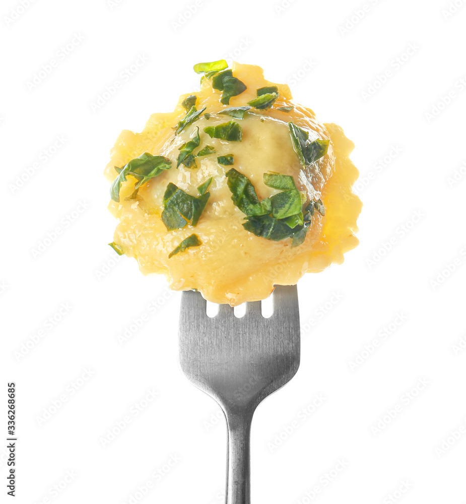 Fork with tasty ravioli on white background