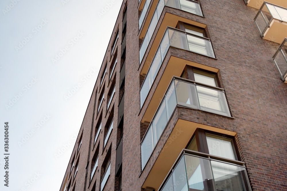 Exterior of new apartment buildings on a blue cloudy sky background. No people. Real estate business