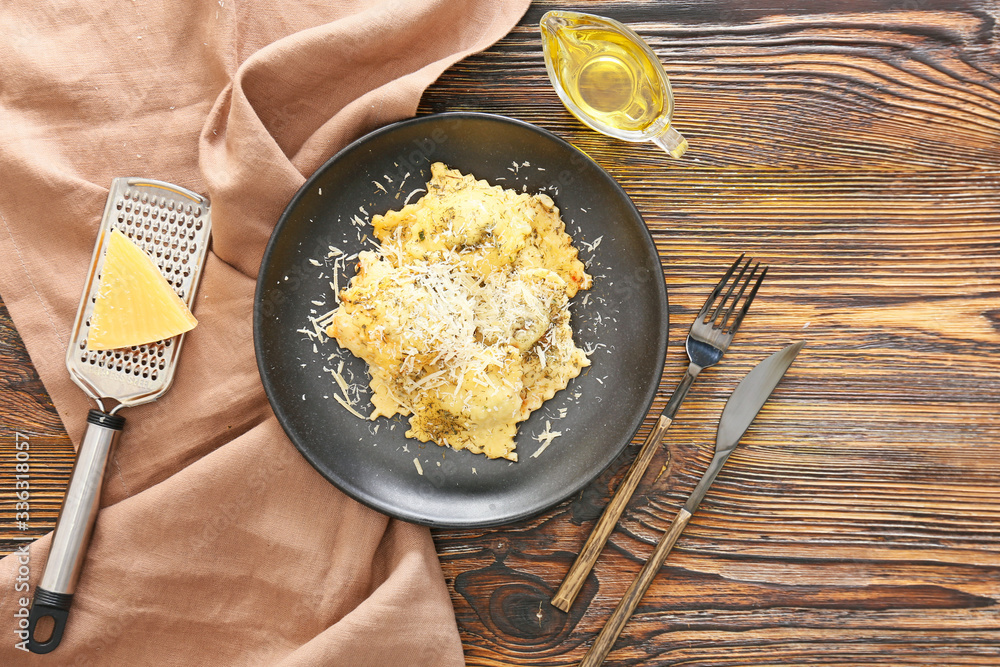 Plate with tasty ravioli on table