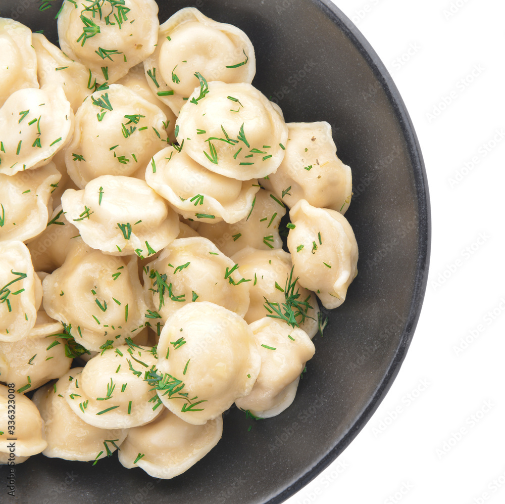 Bowl with tasty dumplings on white background